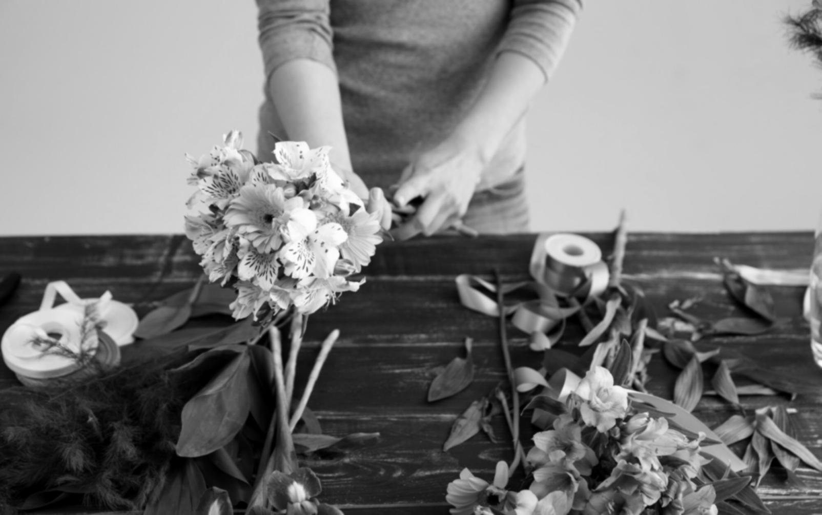 Hands working with fresh flowers during masterclass