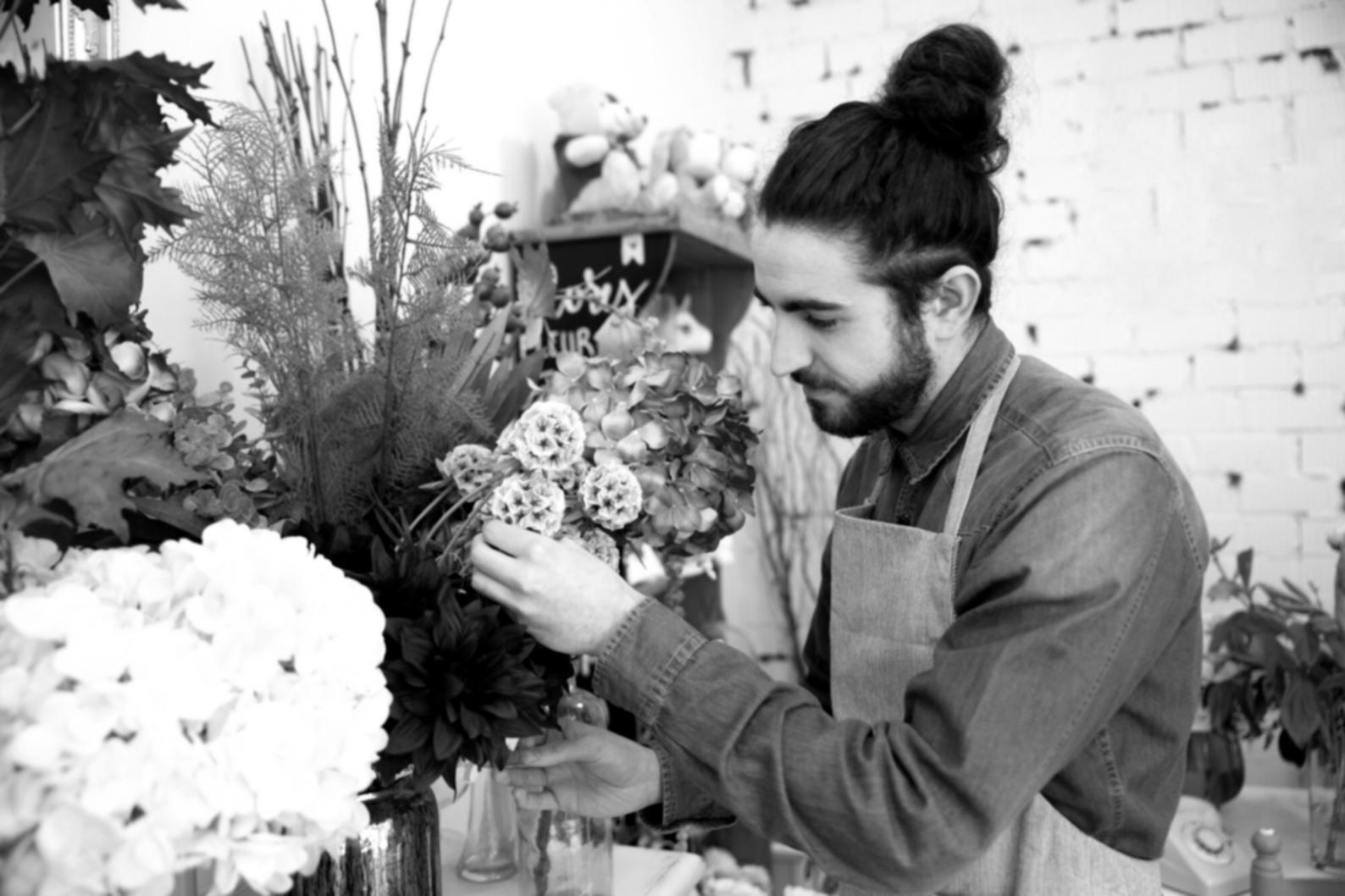 Workshop participants arranging seasonal flowers during group masterclass